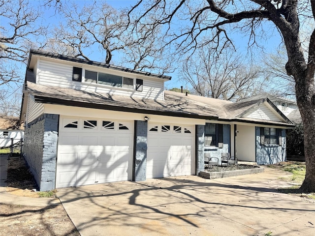 traditional-style house featuring a shingled roof and driveway