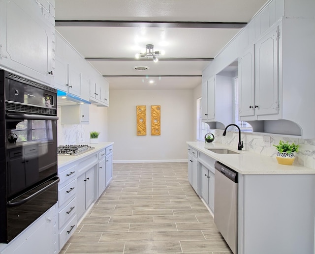 kitchen featuring tasteful backsplash, sink, white cabinets, and appliances with stainless steel finishes