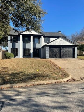 view of front of property featuring a garage and central air condition unit