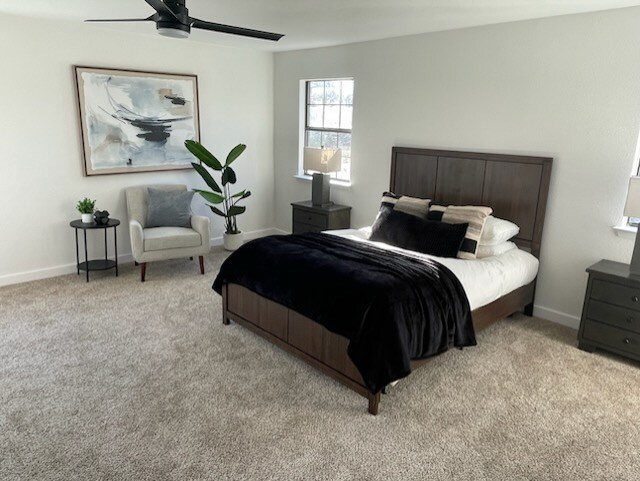 bedroom with ceiling fan and light carpet