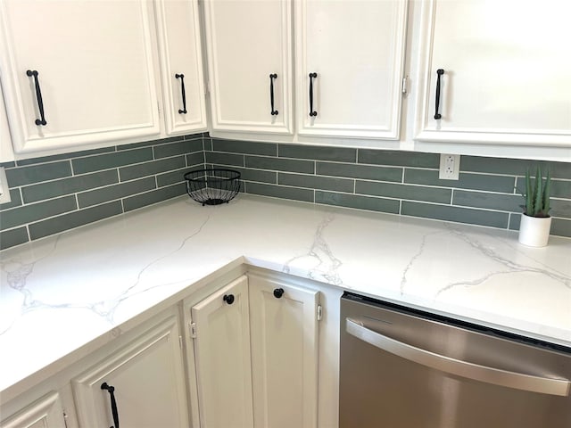 kitchen featuring dishwasher, light stone countertops, and tasteful backsplash