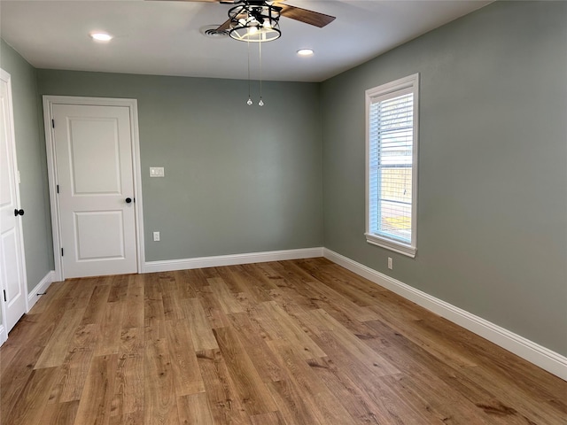 unfurnished room featuring light wood-type flooring and ceiling fan