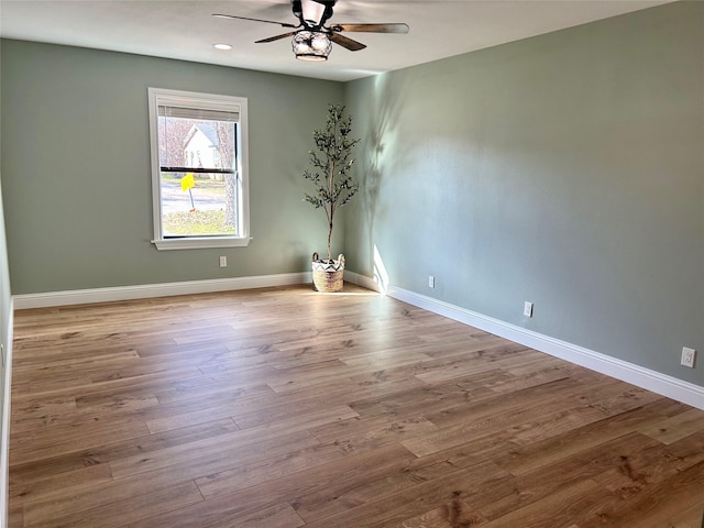 unfurnished room featuring light hardwood / wood-style flooring and ceiling fan