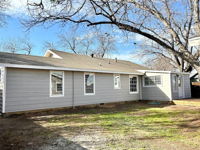 back of property featuring a yard