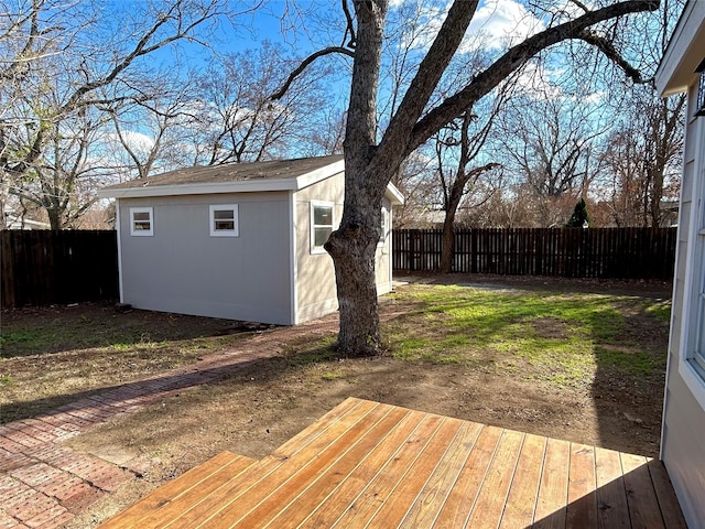 wooden deck featuring a storage unit