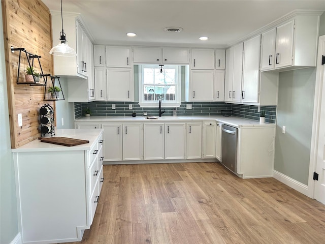 kitchen featuring white cabinetry, sink, dishwasher, and decorative light fixtures