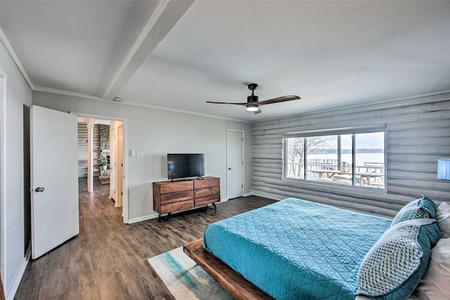 bedroom featuring ceiling fan, log walls, dark wood-type flooring, beamed ceiling, and ornamental molding