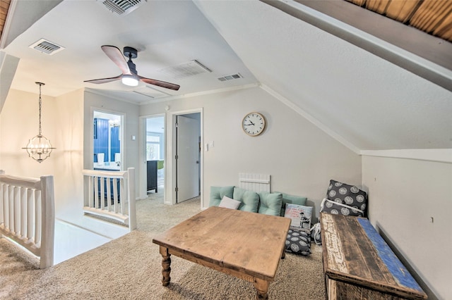 living room featuring ceiling fan with notable chandelier, light colored carpet, and lofted ceiling