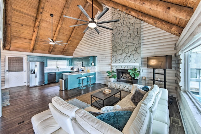 living room featuring high vaulted ceiling, wooden ceiling, beamed ceiling, dark hardwood / wood-style floors, and a stone fireplace