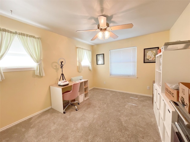 carpeted home office with ceiling fan