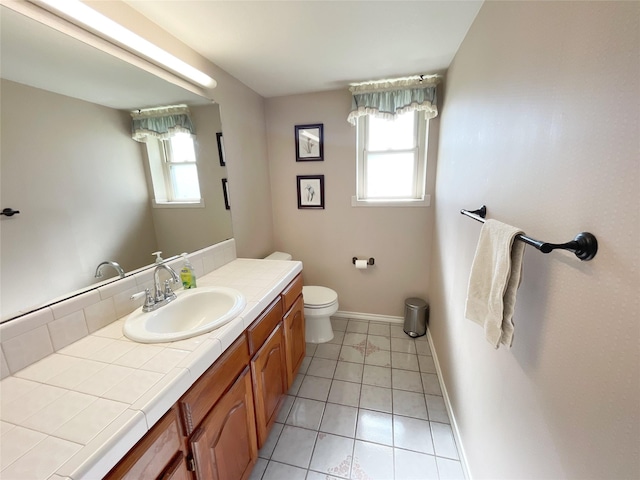 bathroom featuring toilet, vanity, and tile patterned flooring