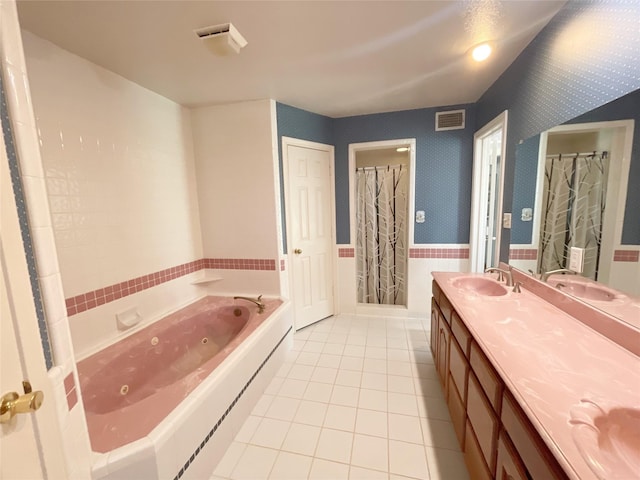 bathroom featuring plus walk in shower, tile patterned flooring, and vanity