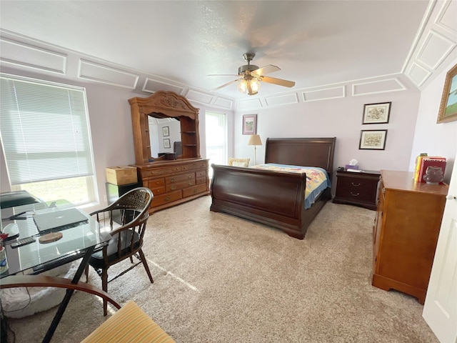 carpeted bedroom featuring ceiling fan and multiple windows