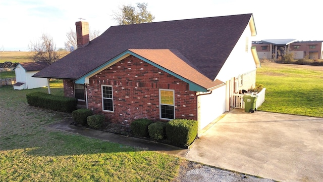 view of side of property featuring a yard and a garage