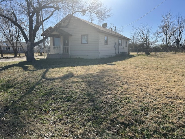 view of property exterior with a yard and central air condition unit