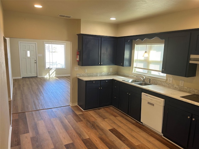 kitchen featuring hardwood / wood-style floors, white dishwasher, pendant lighting, and sink