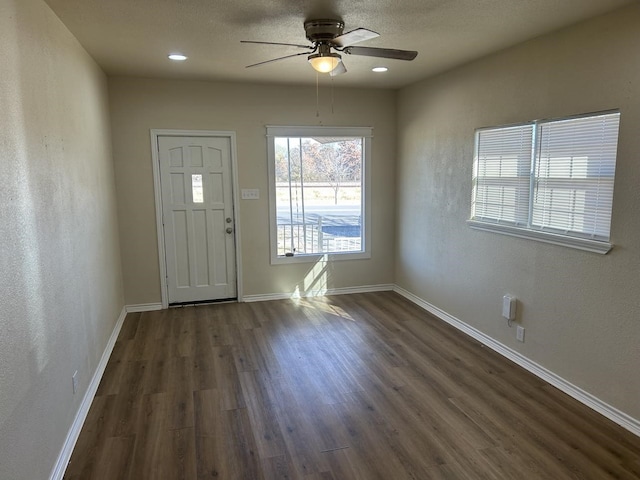 foyer entrance featuring dark hardwood / wood-style floors and ceiling fan