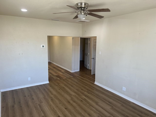 unfurnished room with dark hardwood / wood-style flooring and ceiling fan