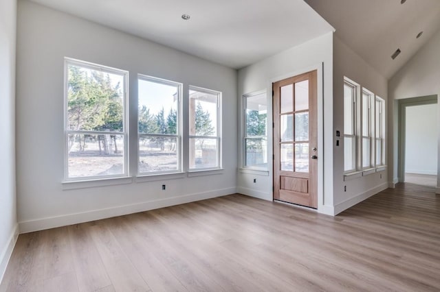 entryway with lofted ceiling and light hardwood / wood-style flooring