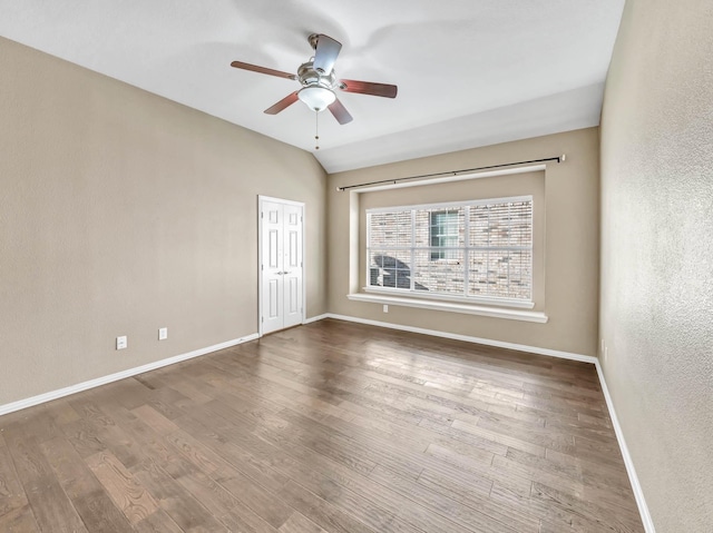 unfurnished room with ceiling fan, wood-type flooring, and lofted ceiling