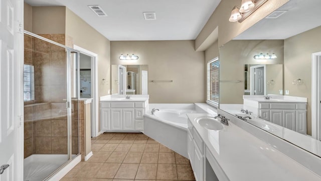 bathroom with tile patterned flooring, vanity, and plus walk in shower