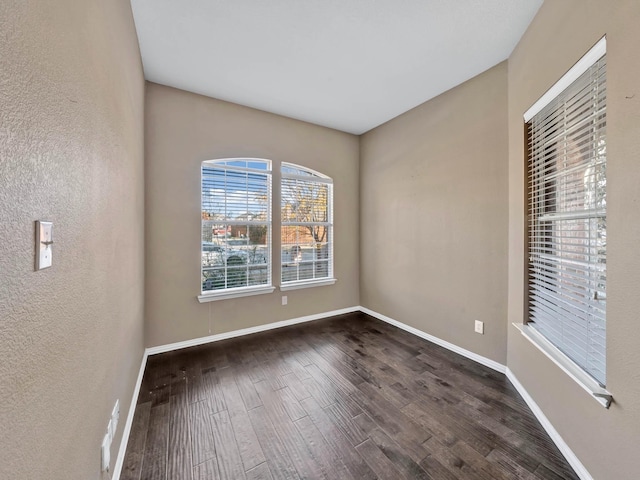 spare room featuring dark wood-type flooring