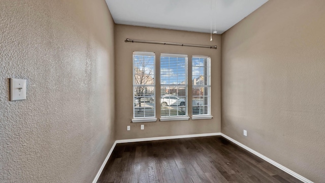 spare room with dark hardwood / wood-style flooring