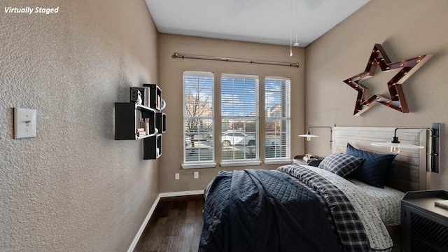 bedroom with dark wood-type flooring