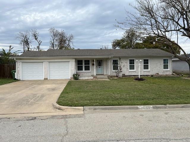 ranch-style home with a garage and a front lawn