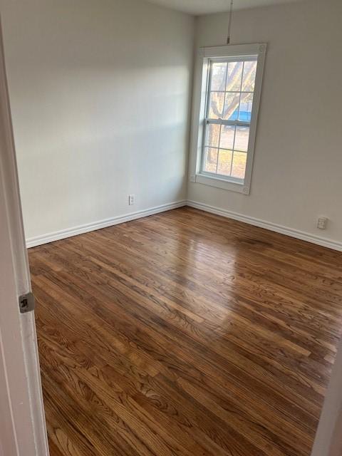 spare room with dark hardwood / wood-style flooring