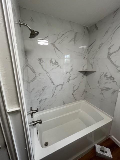 bathroom featuring washtub / shower combination