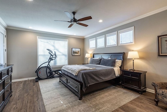 bedroom featuring ceiling fan, dark hardwood / wood-style flooring, and crown molding