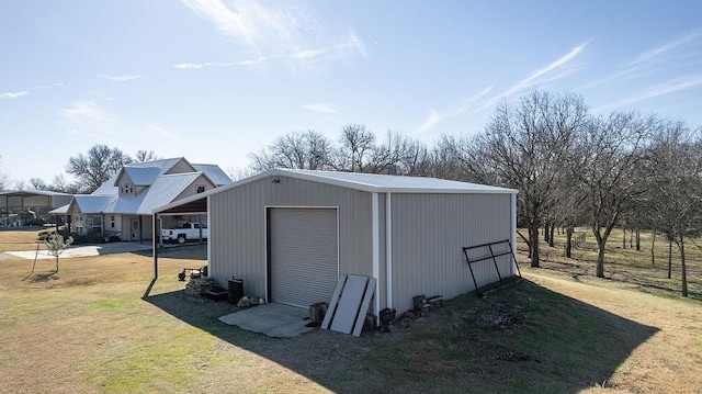 view of outdoor structure with a lawn and a garage