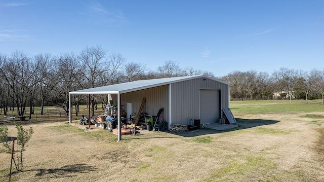 view of outdoor structure with a garage and a yard