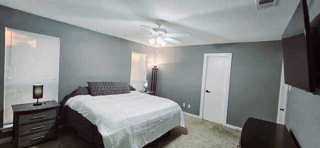 bedroom featuring ceiling fan and light carpet