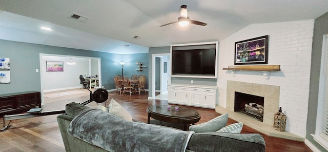 living room with ceiling fan, hardwood / wood-style floors, and lofted ceiling