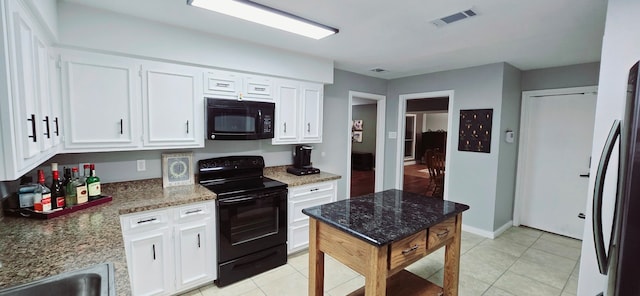 kitchen featuring dark stone counters, white cabinets, black appliances, and light tile patterned floors