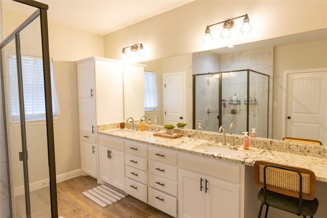 bathroom featuring vanity, an enclosed shower, and hardwood / wood-style flooring