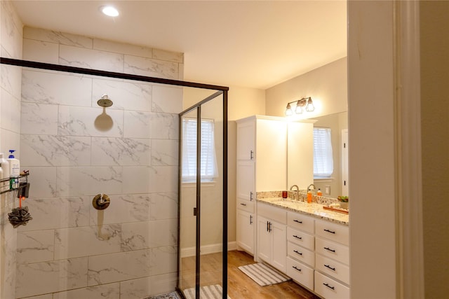 bathroom with vanity, wood-type flooring, and walk in shower