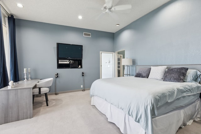 carpeted bedroom with a textured ceiling and ceiling fan