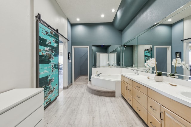 bathroom featuring a high ceiling, vanity, a tub, and wood-type flooring