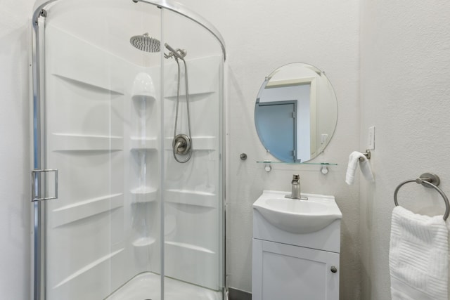 bathroom featuring vanity and an enclosed shower