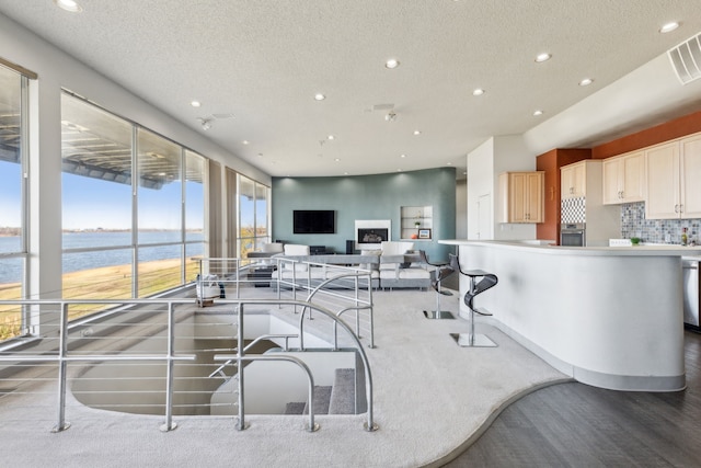 interior space with stainless steel appliances, a textured ceiling, and tasteful backsplash