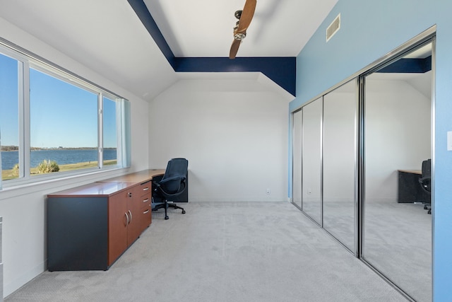 carpeted office space with a water view and vaulted ceiling