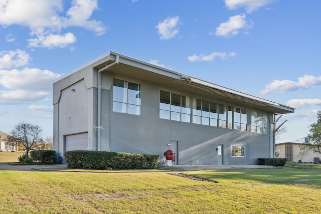 view of side of property featuring a yard and a garage