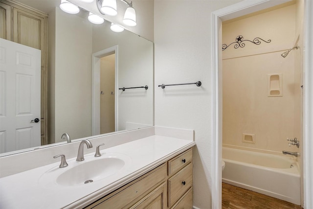 full bathroom featuring vanity, toilet, wood-type flooring, and bathtub / shower combination