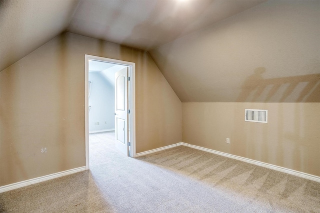 bonus room featuring lofted ceiling and light carpet