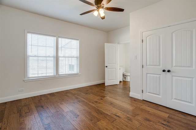 unfurnished bedroom featuring ceiling fan, dark wood-type flooring, and a closet