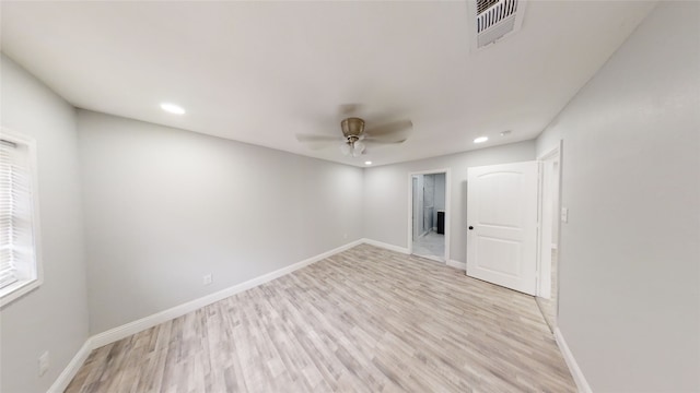 empty room featuring ceiling fan and light wood-type flooring