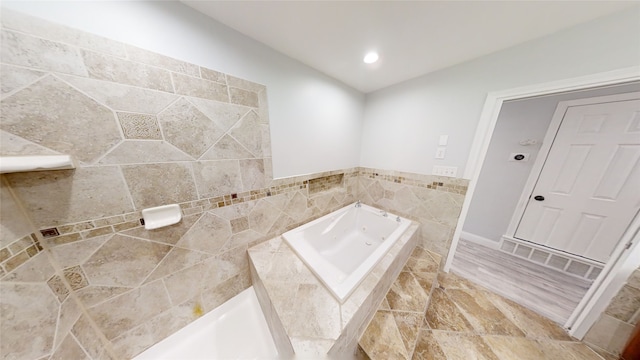 bathroom with tiled tub